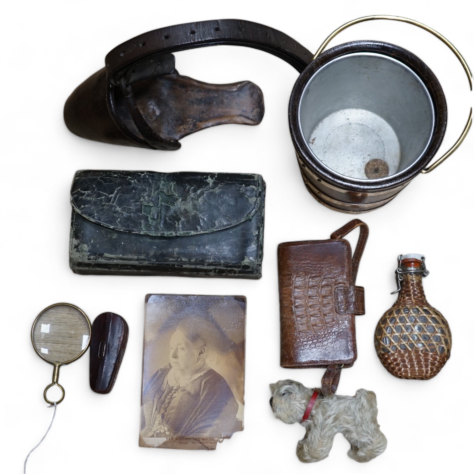 A collection of sundry items to include a fisherman's fly tying kit, a crocodile skin purse, a travelling inkwell, a miniature Steiff dog and a leather stirrup. etc. (9). Condition - mostly fair